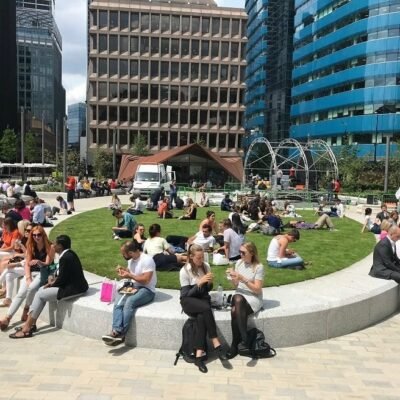 People sitting within a public space in Aldgate Square