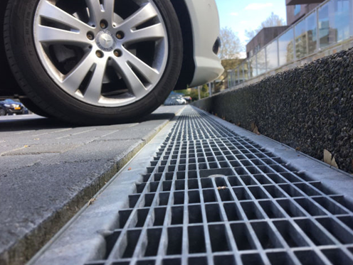Drainage channel in car park against a kerb