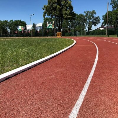 Track and field ground with kerbing boundary