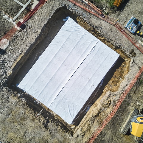 Birds-eye view of rainwater retention tank constructed with DRAINFIX BLOC HD crates, covered in impermeable geomembrane